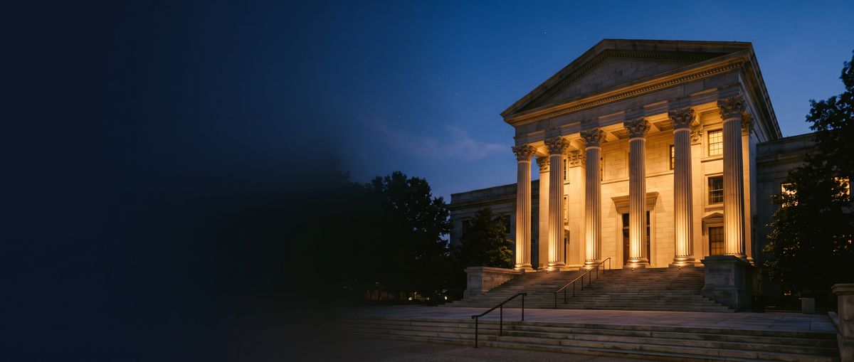 Columned courthouse lit up at night